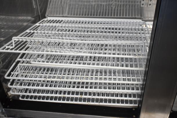 Kool It KBSF-2 commercial 2-door freezer interior showing wire shelves. Used condition, on commercial casters. 115 volts, 1 phase.