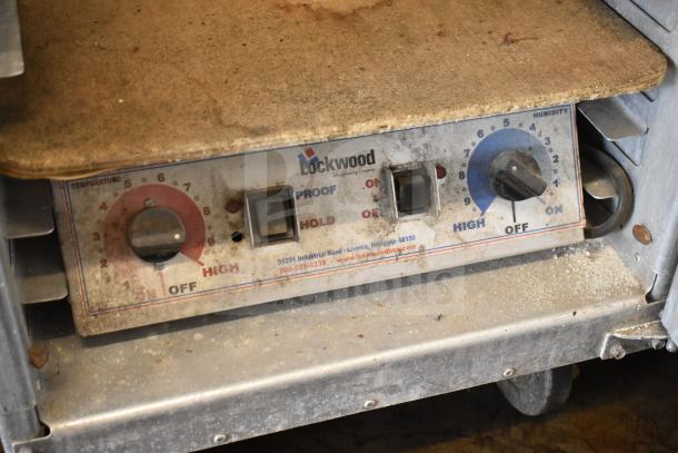 Lockwood heated holding pan rack on commercial casters; features temperature and humidity controls; used condition.