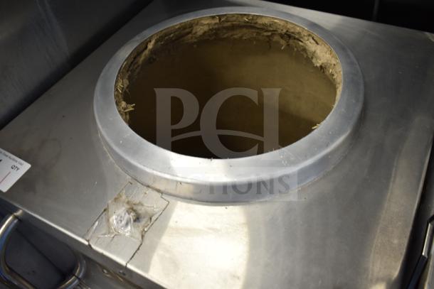 Puri Commercial Tandoori Clay Oven with metal finish, in used condition, on commercial casters for mobility.
