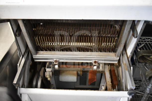 Oliver 777 commercial bread loaf slicer, floor style, 115 volts, 1 phase. Visible blades and mechanics, in used condition.