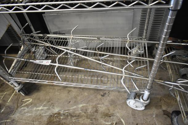 Four stainless steel rotisserie oven skewers displayed on a metal rack, labeled "Lot 168, Qty 4x," ideal for commercial use.