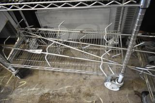 Four stainless steel rotisserie oven skewers displayed on a metal rack, labeled "Lot 168, Qty 4x," ideal for commercial use.