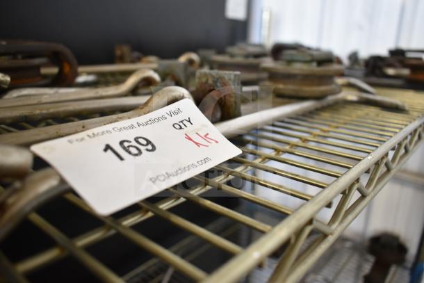 15 trolley rollers on a metal shelf. Auction lot tag 169 with quantity 15, via PCLAuctions.com.