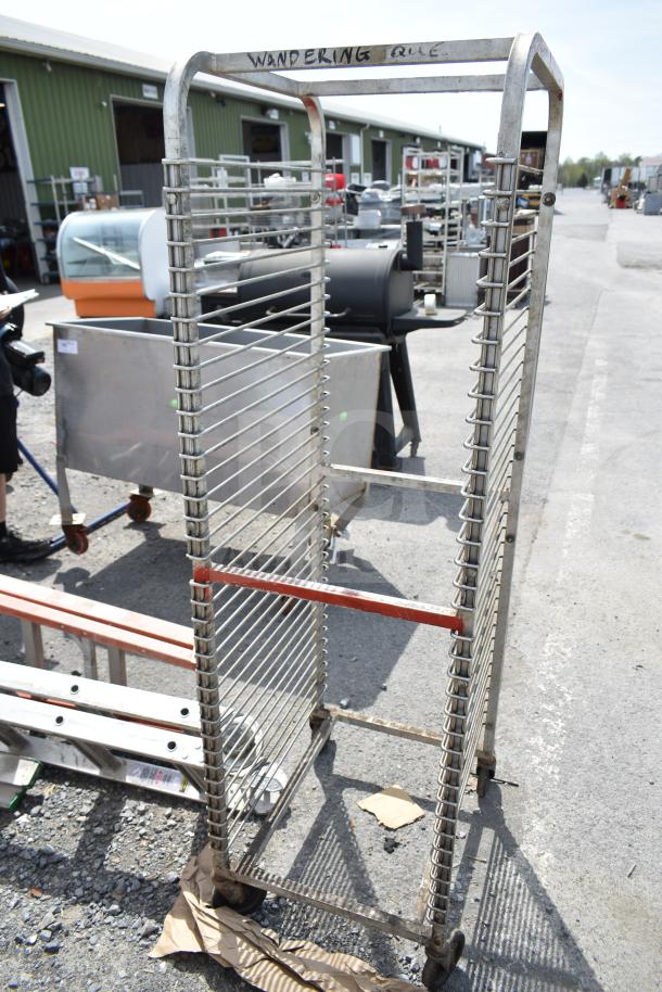 Commercial pan transport rack with metal shelves and casters. Marked "WANDERING". Used condition. Ideal for bakery use.