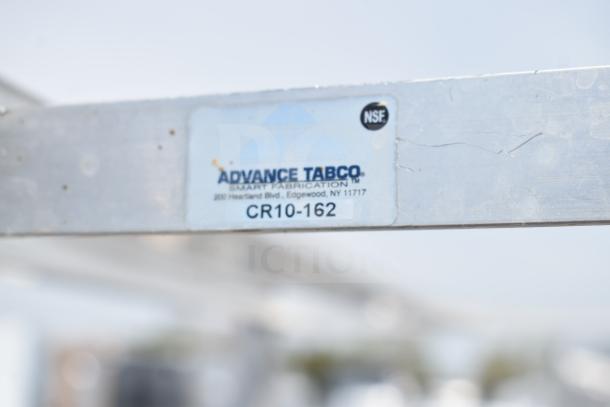 Commercial #10 can rack, Advance Tabco model CR10-162, with casters, NSF certified, visible wear on metal surface.