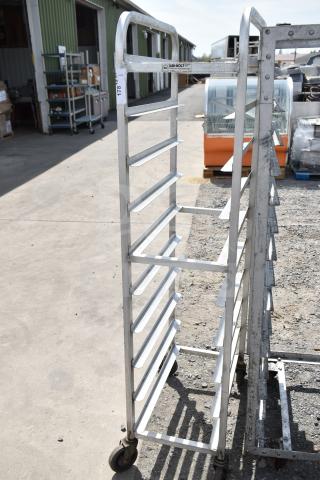 Commercial pan transport rack on sturdy casters, 12-shelf capacity, metal frame, ideal for bakery use, good condition.