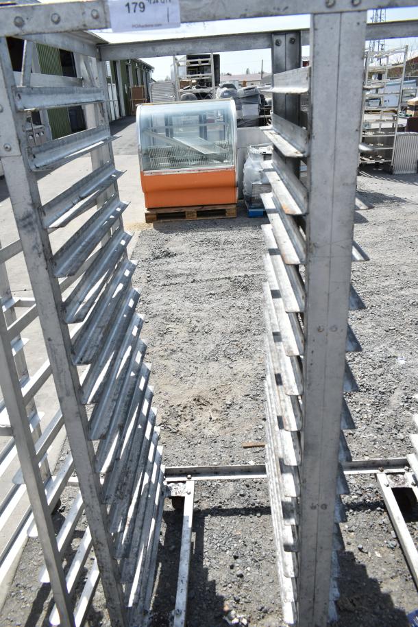 Commercial double pan transport rack on casters, metal frame, used condition, label indicates auction lot number 179.