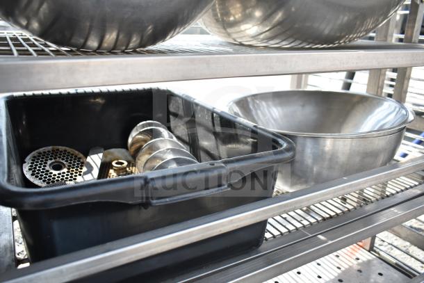 Commercial transport rack on casters with metal bowls and black bin containing metal parts. Durable and versatile.