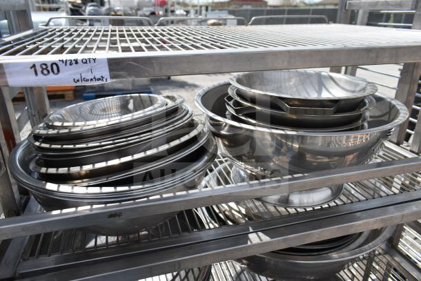 Steel transport rack on casters with metal bowls, labeled "180 4/28 QTY w/contents," in used condition.