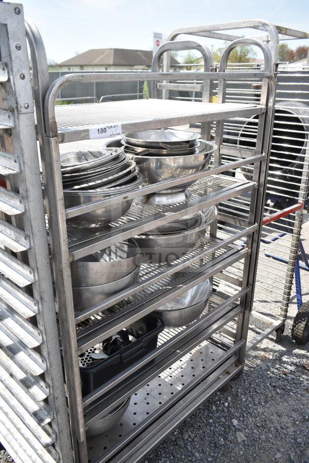 Commercial transport rack on casters with metal bowls; sturdy stainless steel, well-maintained, includes various bowl sizes.