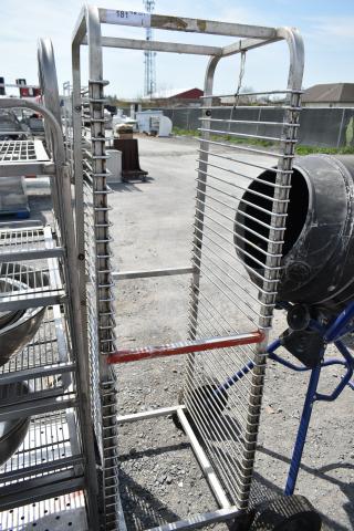 Commercial pan transport rack on wheels, sturdy metal frame, multiple shelves, and commercial casters for easy mobility.