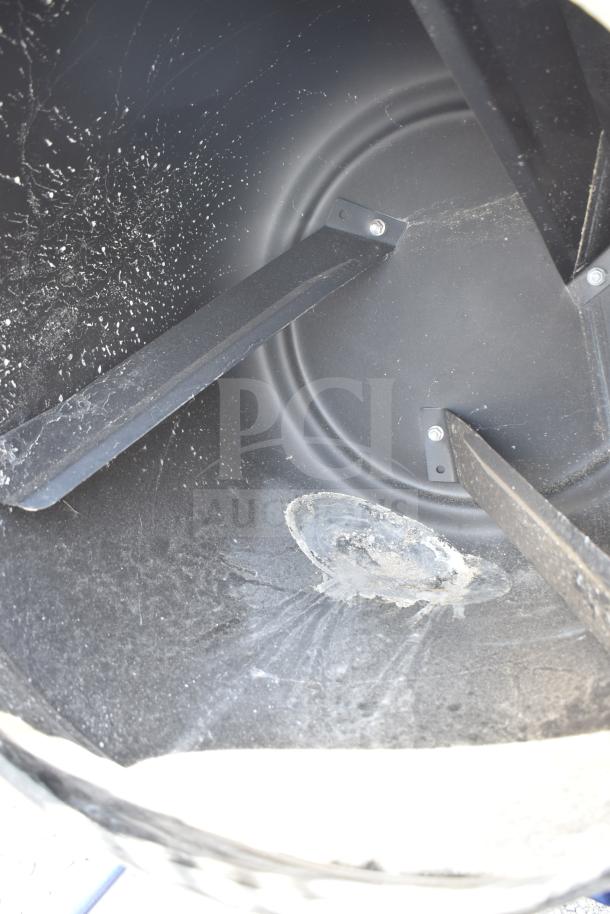 Kobalt 0241568 Concrete Mixer, interior view, showing mixing paddles and drum, in used condition with visible cement residue.
