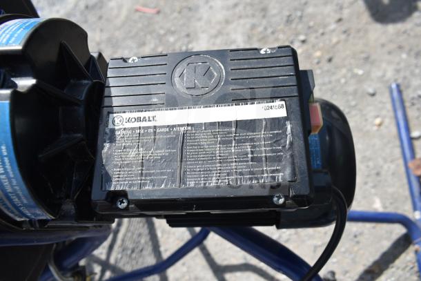 Kobalt 0241568 Concrete Mixer close-up showing brand logo, model number, and warning label; appears in used condition.