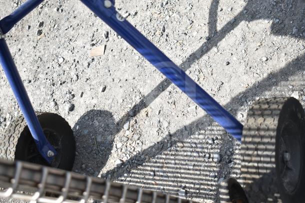 Kobalt 0241568 Concrete Mixer frame and wheel close-up, showing sturdy metal construction and rugged wheels.
