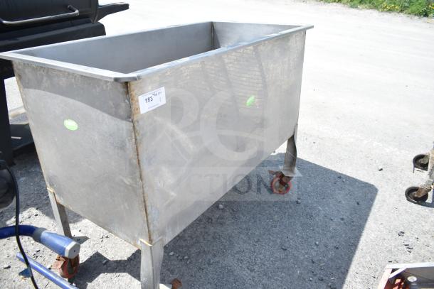 Commercial portable bin on casters, metal, with visible wear. Tag indicates item number 183, some rust on wheels.