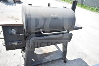 Pit Boss PB1500NX Savannah Pellet Grill with commercial casters, showing wear, includes control panel with Pit Boss logo.