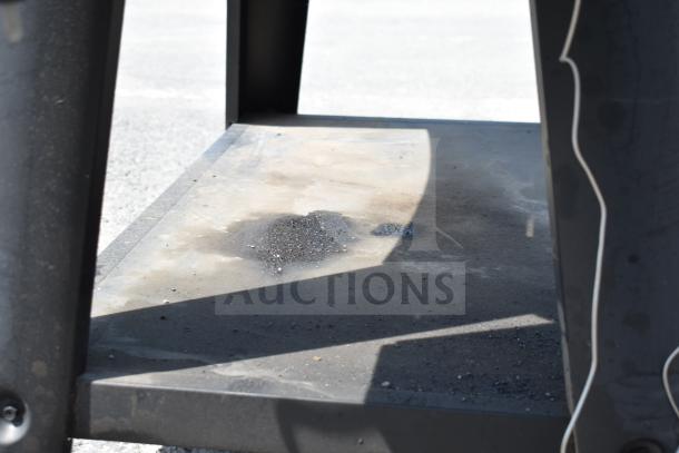 Pit Boss PB1500NX Savannah Pellet Grill with commercial casters, shows signs of use with ash accumulation, sturdy build.