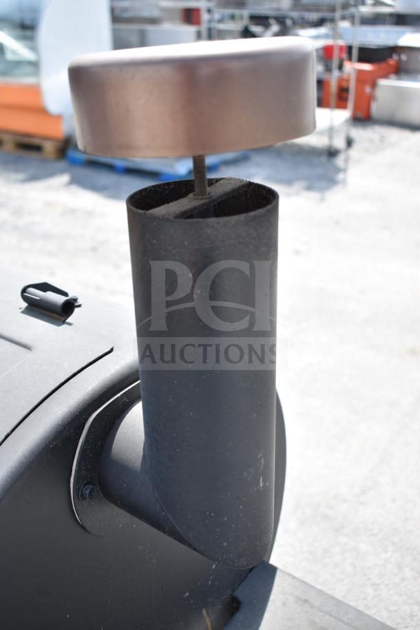 Pit Boss PB1500NX Savannah Pellet Grill, black chimney detail, on commercial casters, sturdy outdoor design, excellent condition.
