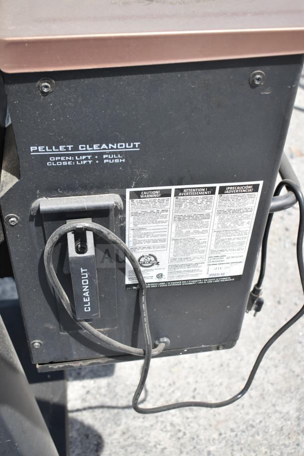 Pit Boss PB1500NX Savannah Pellet Grill, showing pellet cleanout and safety instructions. Features commercial casters.