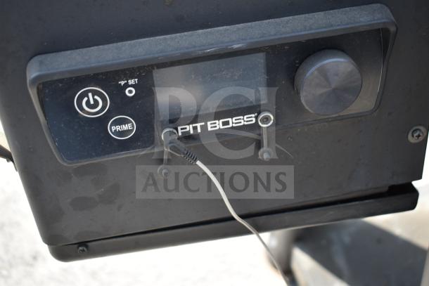 Pit Boss PB1500NX Savannah Pellet Grill control panel, featuring power and prime buttons, on commercial casters.
