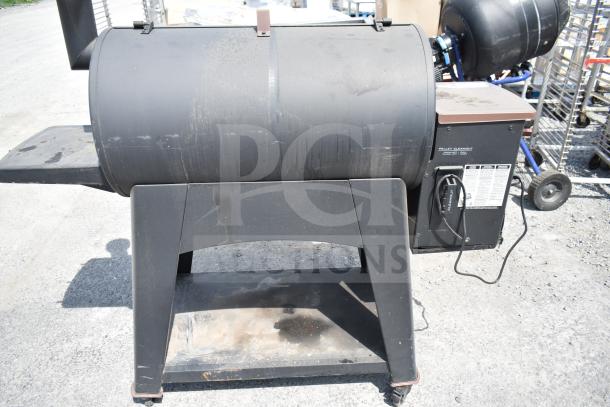 Pit Boss PB1500NX Savannah Pellet Grill, used condition, commercial casters, visible labels for pellet cleanout.