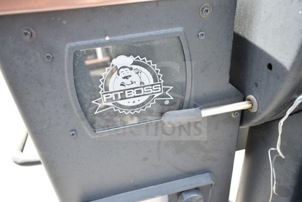 Pit Boss PB1500NX Savannah Pellet Grill, black metal finish, logo on side, commercial casters, sturdy build.