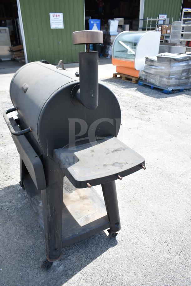 Pit Boss PB1500NX Savannah Pellet Grill with commercial casters, black finish, visible wear, model tag on side.
