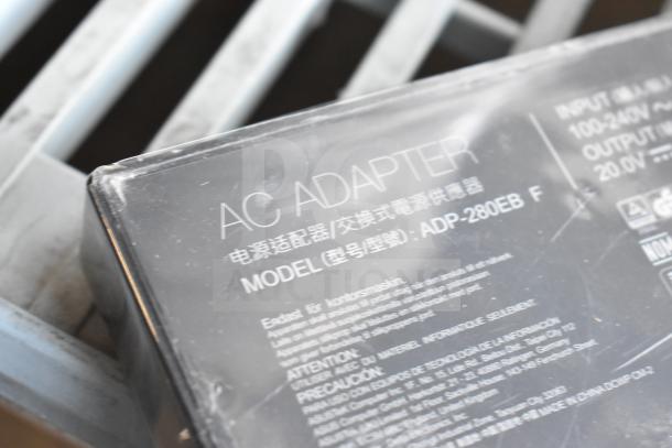 AC adapter with model ADP-280EB F, various cables, lightly worn, visible input/output specs, includes 10 items, auction lot.