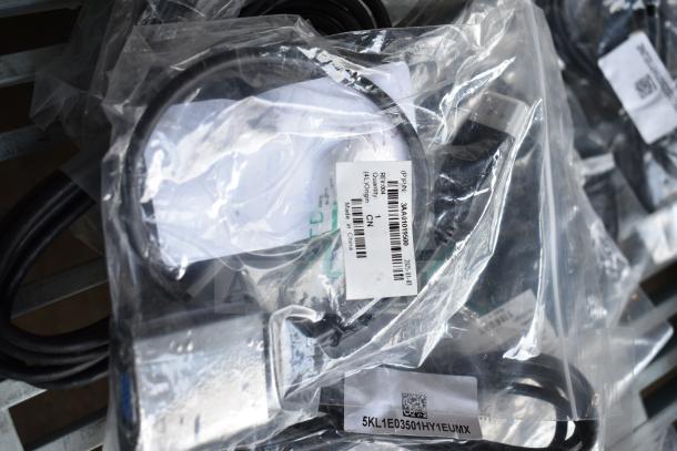 Sealed bags containing assorted items including an AC adapter and cables. Visible labels indicate part numbers and origin.