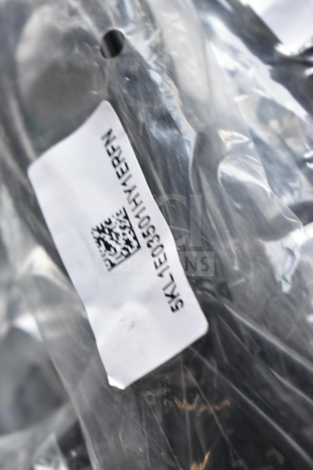 Plastic bag containing various items, including an AC adapter and cables. Visible barcode and SKU label: SK-L1E03OHV1EPRN.