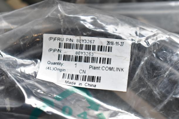 Plastic-wrapped bundle of items including AC adapter, cables; label: FRU P/N 80Y3267, made in China, dated 2018-11-27.