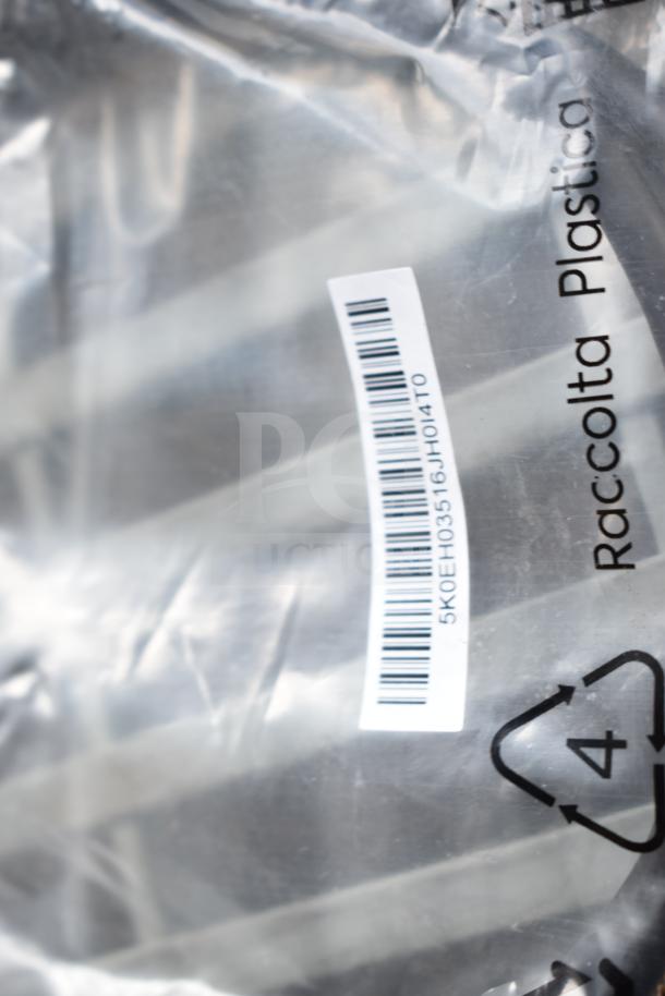 Clear plastic bag with visible barcode and recycling symbol on its surface. Contains various electronics including an AC adapter and cables.