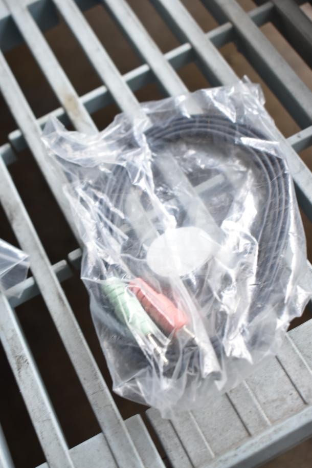 Plastic bag containing a coiled cable with red and green connectors on a metal surface. Part of a 10-item auction lot.