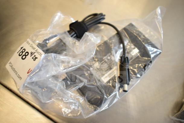 Bag containing various items, including a Belkin F2CD058 HDMI cable and AC-DC adapter, labeled for auction with item number 188.