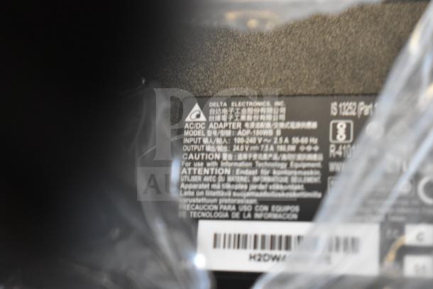 AC/DC Adapter Delta Electronics Model ADP-180WB B, input 100-240V, output 19.5V 9.23A. Label with specs visible.