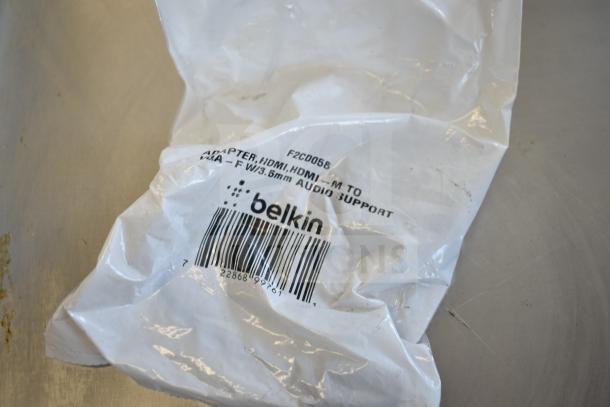 Belkin F2CD058 HDMI cable in plastic packaging with visible barcode and labeling. 9 items total in auction lot.