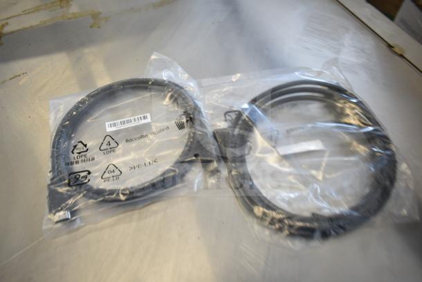 9 assorted items including a Belkin F2CD058 HDMI cable and an AC-DC adapter, packaged in clear plastic bags.