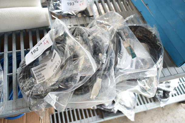 Nine assorted cables in packaging, including Zebra CBA-U52-S16PAR, auction lot 192, new condition.