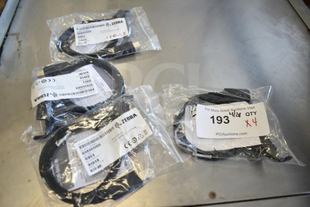 Four Zebra CBL-TC55-CHG1-01 charging cables, new in packaging, labeled with product information and auction details.