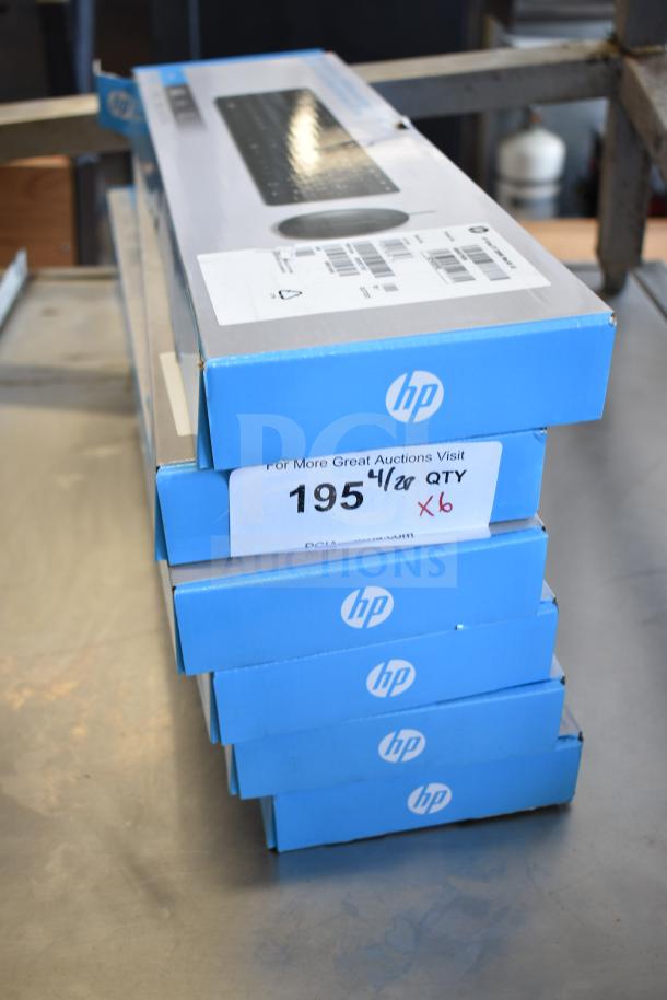 6 new HP wired keyboard and mouse sets, scratch and dent condition, stacked in blue boxes, auction label shows "195" and "X6".