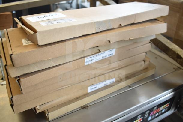 Stack of eight sealed brown boxes labeled "Scratch and Dent" keyboards, showing minor packaging wear.
