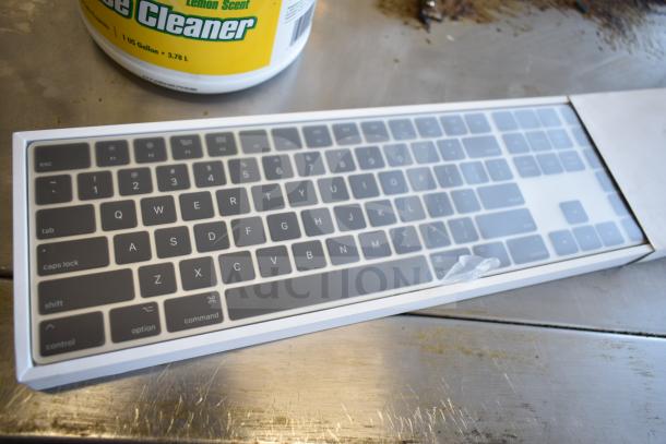 Brand new Logitech keyboard in packaging with visible scratch and dent damage.