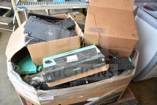 Pallet containing various keyboards, including boxed Logitech models, in mixed condition.