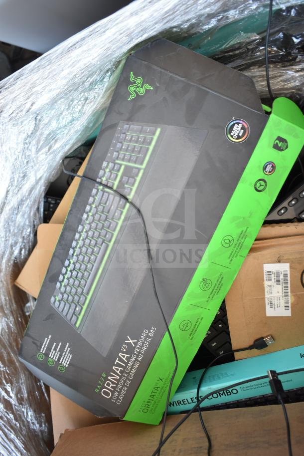 Pallet of various keyboards including boxed Razer Ornata V3 X. Mixed condition, includes wired and wireless options.