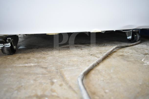 Brand new KoolMore KM-GDC-26SD gelato cabinet on casters; 5 pans, 6 cu. ft., sliding glass door; scratch and dent visible.