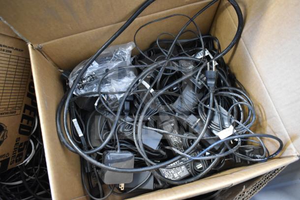 Pallet lot of GenSpeed Cat 5e riser cables, mixed lengths, in a cardboard box. Condition varies; some cables appear tangled.