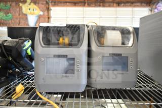 Two Zebra ZD621 Desktop Direct Thermal Barcode Printers on a shelf; display screens and buttons visible; used condition.