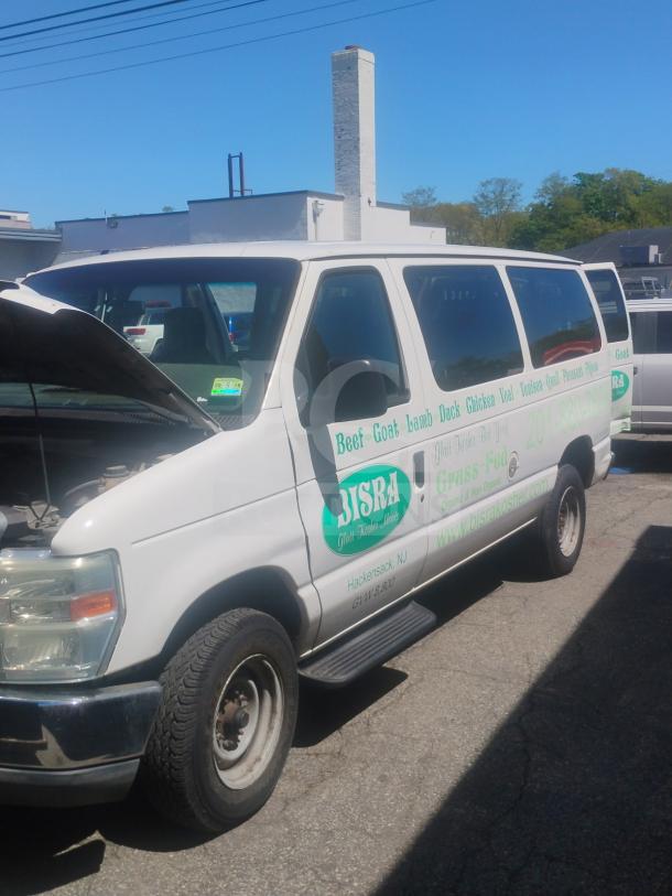 2010 Ford E350 Cargo Van in white, commercial use, visible logo, runs and drives, 162,472 miles, clear title.