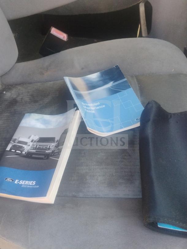 Ford E-Series 2010 owner's guide and maintenance manual on van seat.