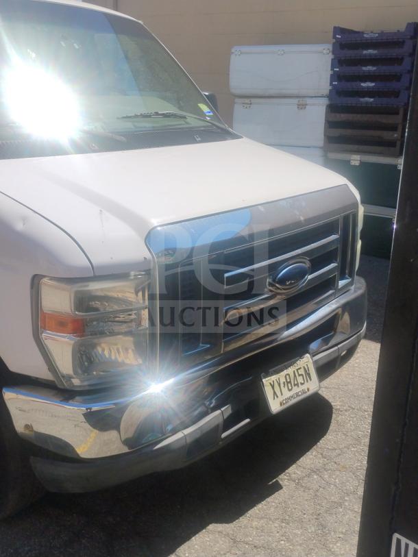 2010 Ford E350 Cargo Van front view, license plate visible. White exterior, odometer 162,472 miles, clear title.